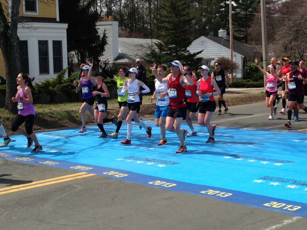 Boston Marathon runners in the 3:30 finish range wave to the camera at Km30/Mile 18 in Newton on April 15, 2013