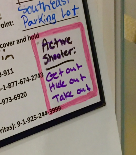 An active shooter reminder on a whiteboard at a corporate site